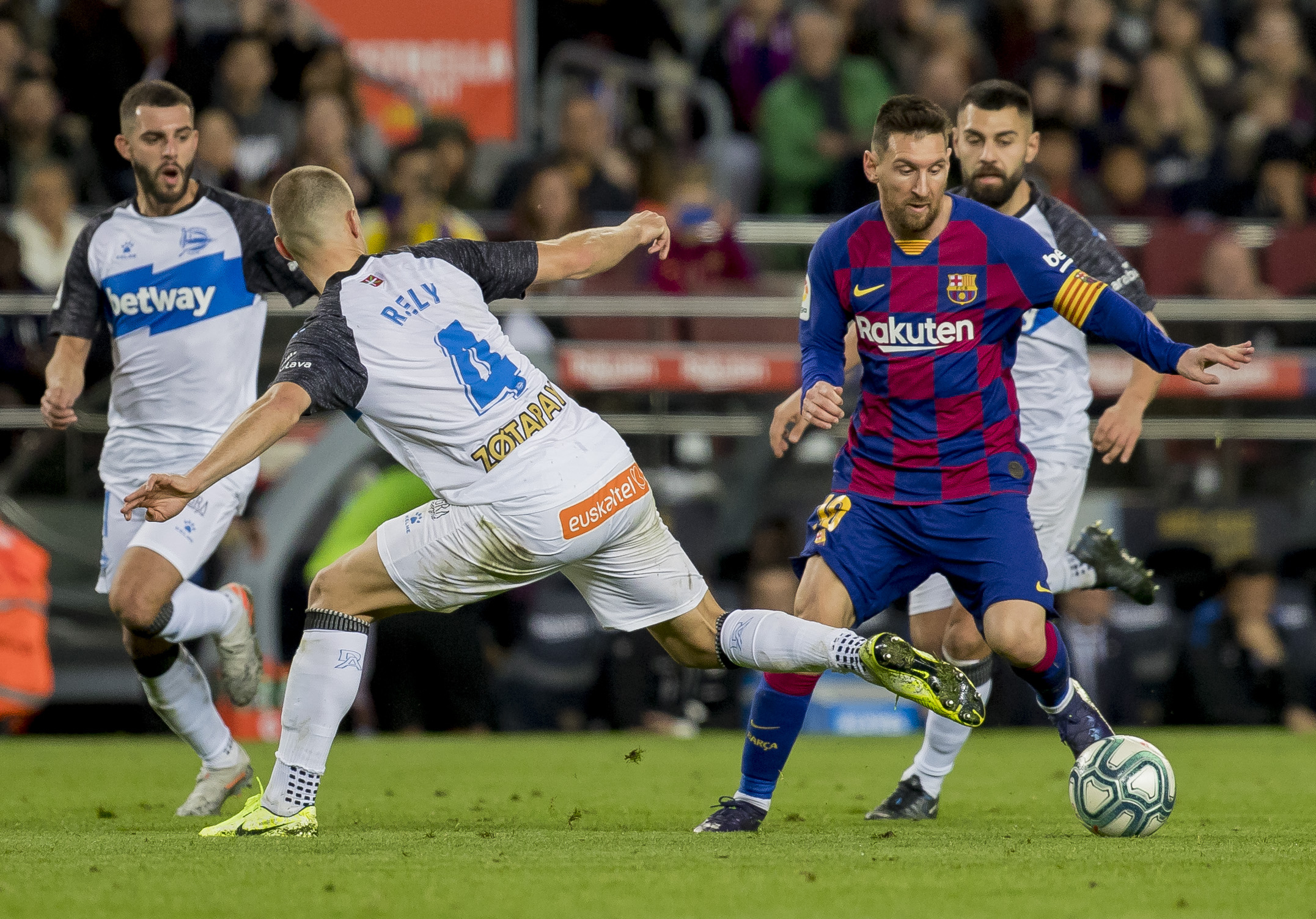Barcelona's Lionel Messi, left, drives the ball during a Spanish La Liga soccer match between Barcelona and Alaves at Camp Nou stadium in Barcelona, Spain, Saturday, Dec. 21, 2019. (AP Photo/Joan Monfort)